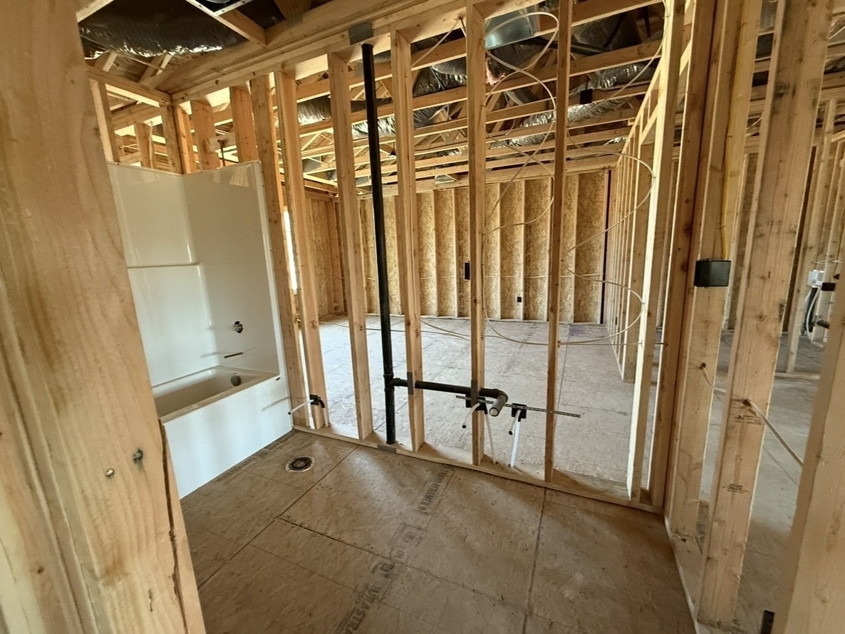 Bathroom framing with rough-in plumbing visible