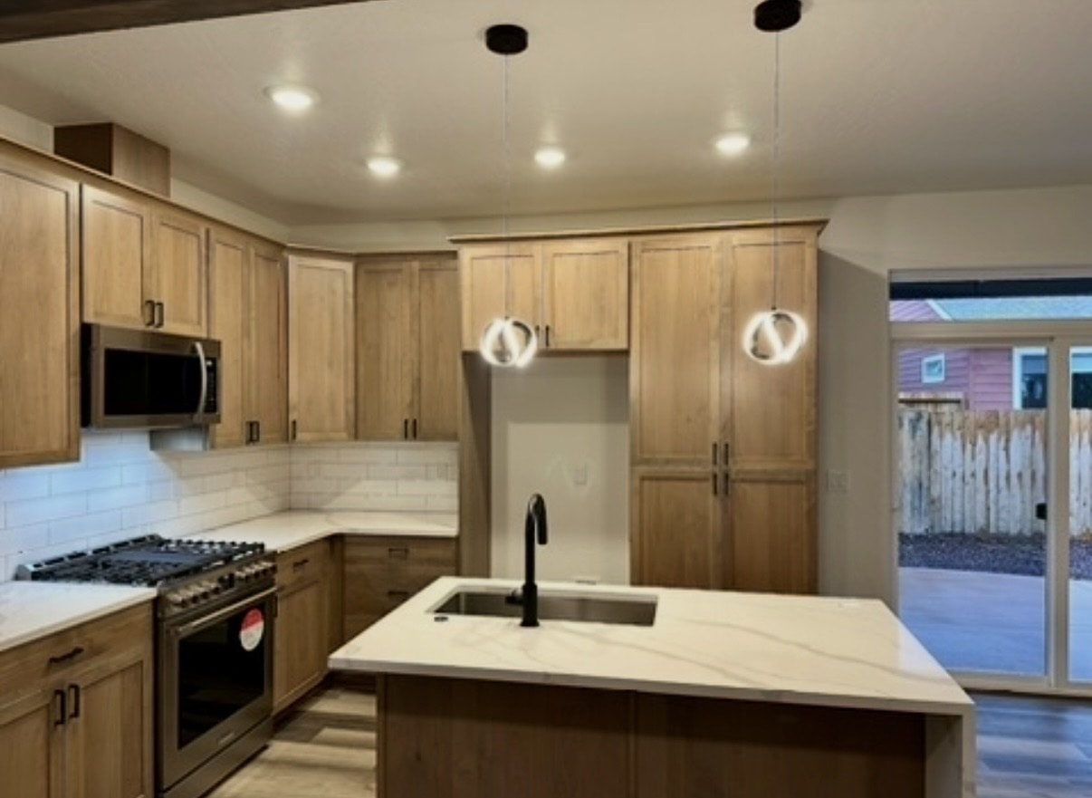Finished kitchen with wood cabinets — final construction cleaning complete